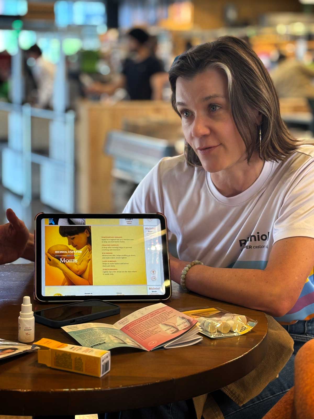 Nina training Whole Foods staff on Riciniol at an in-store table